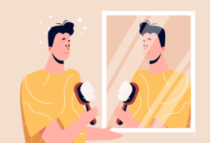 Young, fit man looking in the mirror with healthy hair growth.