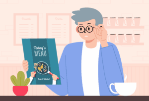 Older man noticing cloudy or blurred vision while reading, a common cataract symptom.